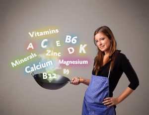 Pretty young woman cooking vitamins and minerals